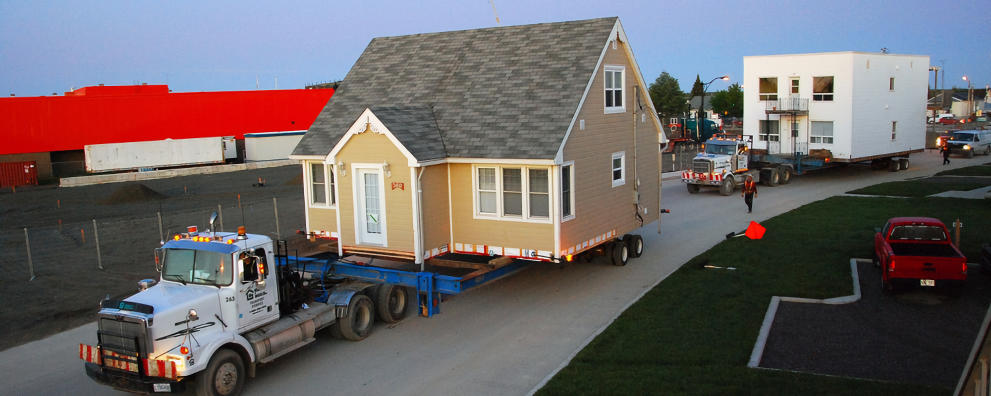 Houses being loaded on trucks in Malartic, Quebec.